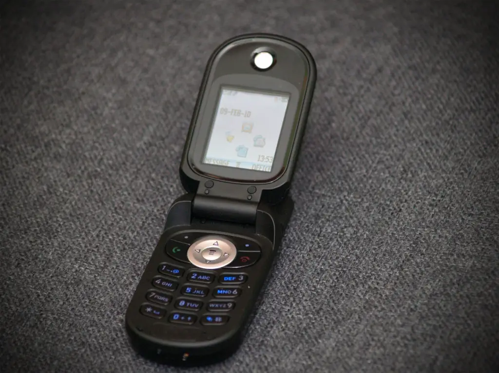 Old style classic black flip phone used as a fake number for WhatsApp.