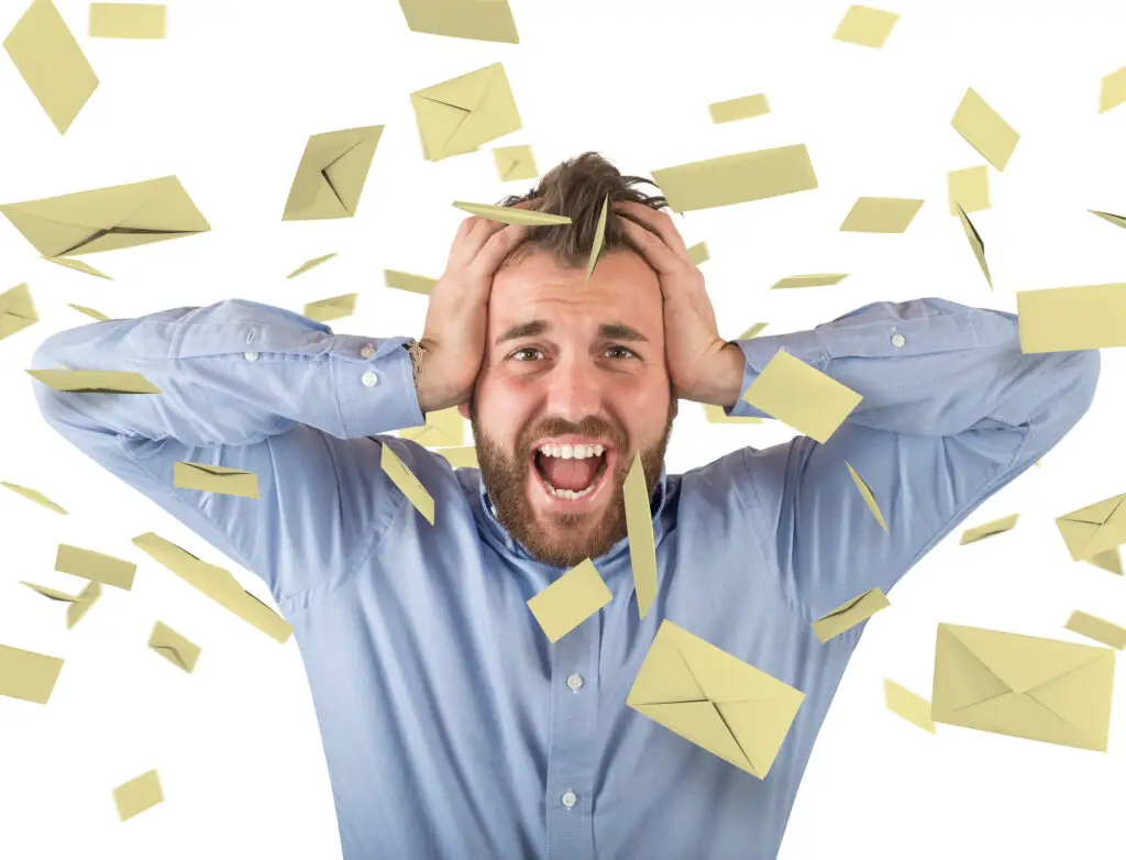 Man with hands on his head and spam messages falling around him after using a free number for WhatsApp
