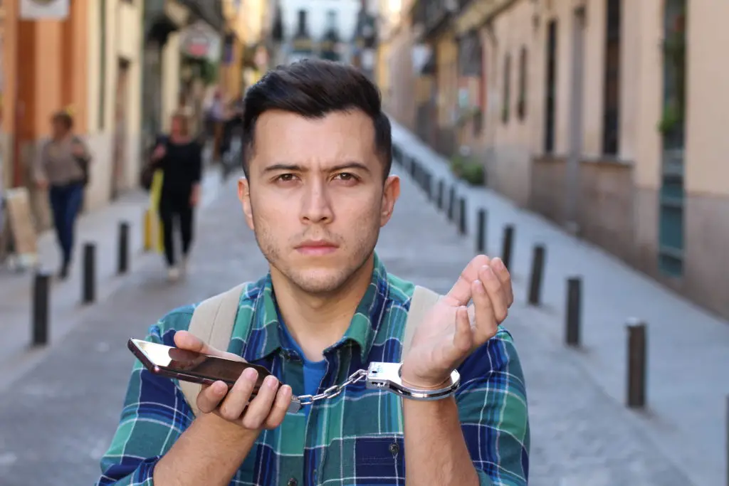 Man handcuffed to his phone.