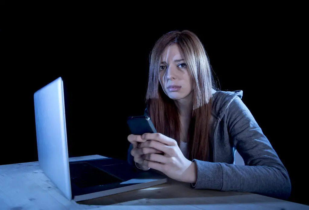 Teen with laptop and smartphone worried if you can see search history on the phone bill or WiFi logs