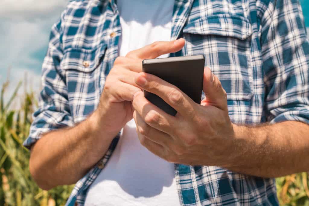 Man holding smartphone texting wondering if it's sent over WiFi