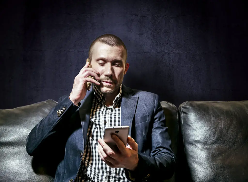 Business man using a personal and work phone
