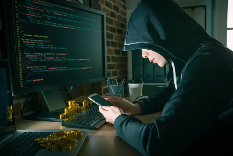 Hooded woman hacker using her private Android keyboard to type messages