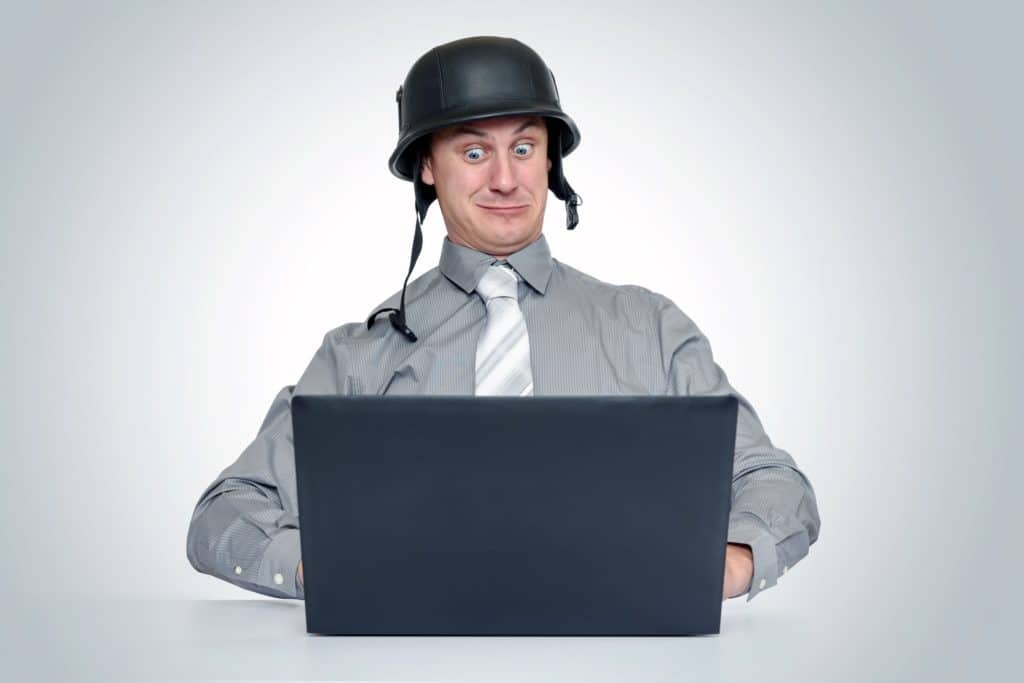 Man wearing helmet protecting his laptop from pdfs containing viruses