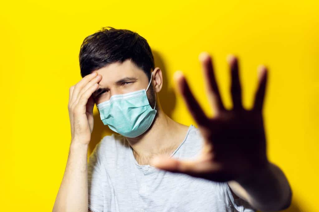 Worried man wondering: can a computer virus infect a human