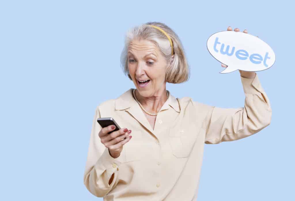 Woman holding smartphone and speech bubble reading "tweet" learning social media synonyms