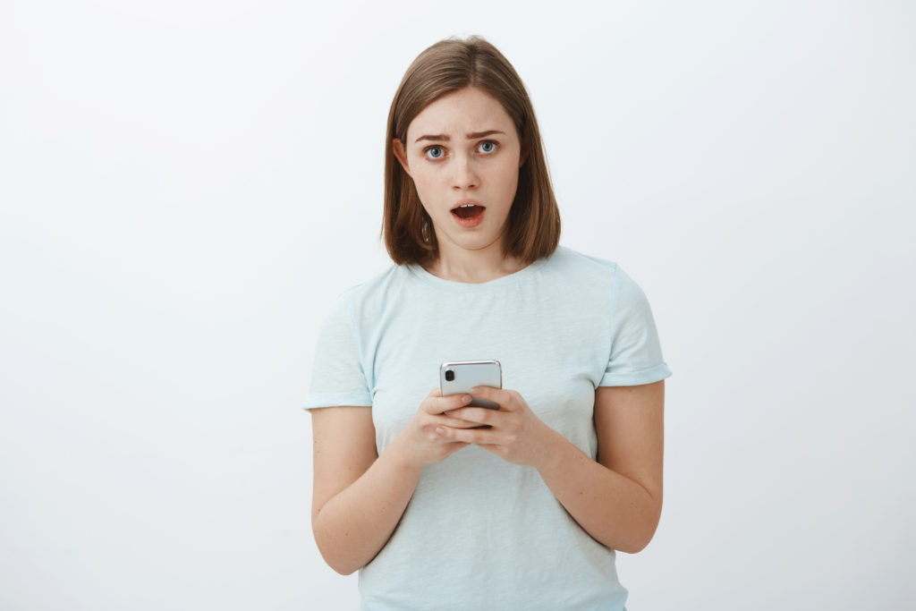 Worried woman just clicked a phishing link on her smartphone