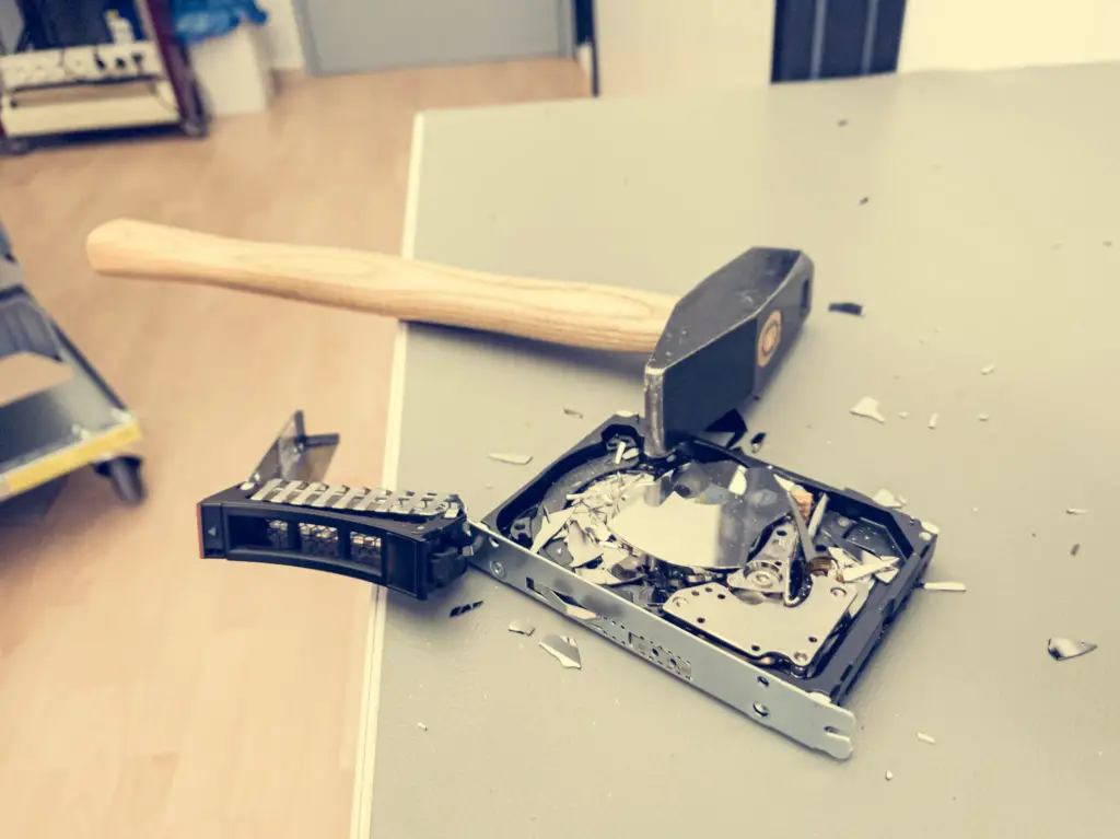 Smashed hard drive on a desk having been pulled from a secure computer