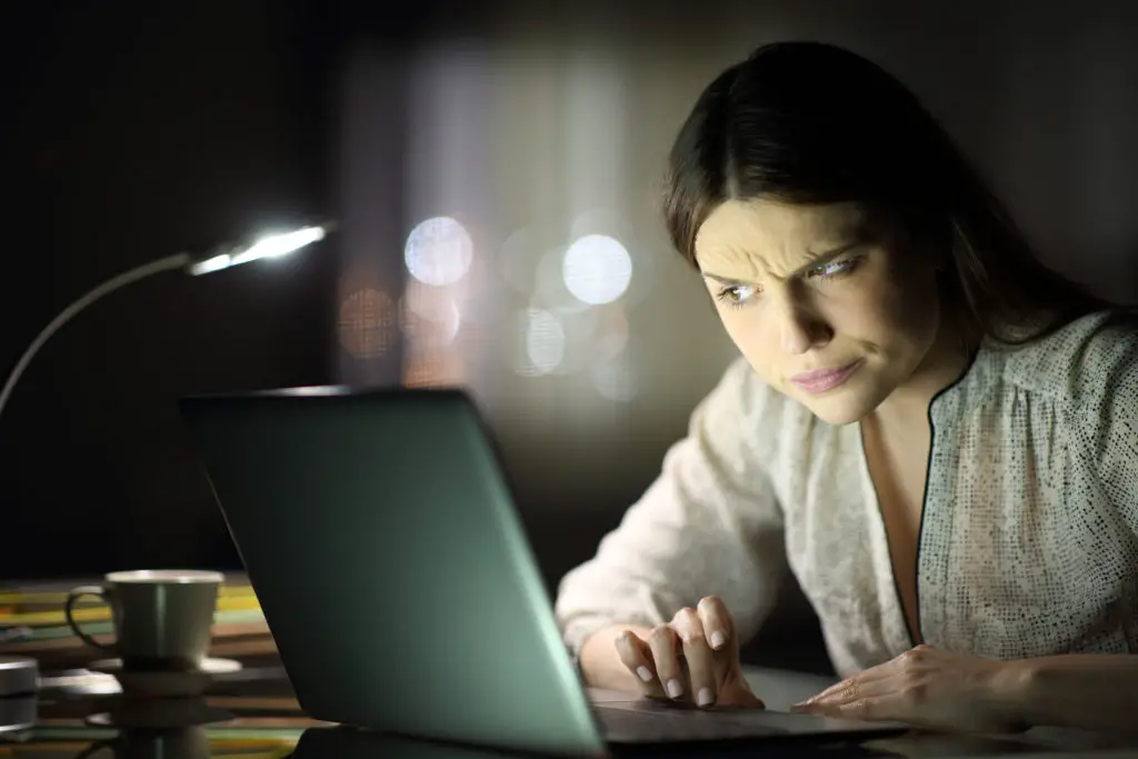 Woman using a laptop wonder if she can create a fake email address in gmail