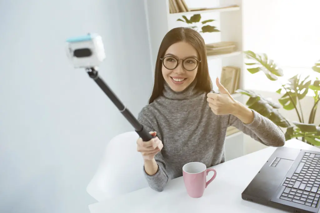 Youtube creator using a selfie stick to record video to post on an alternative youtube advert-free platform