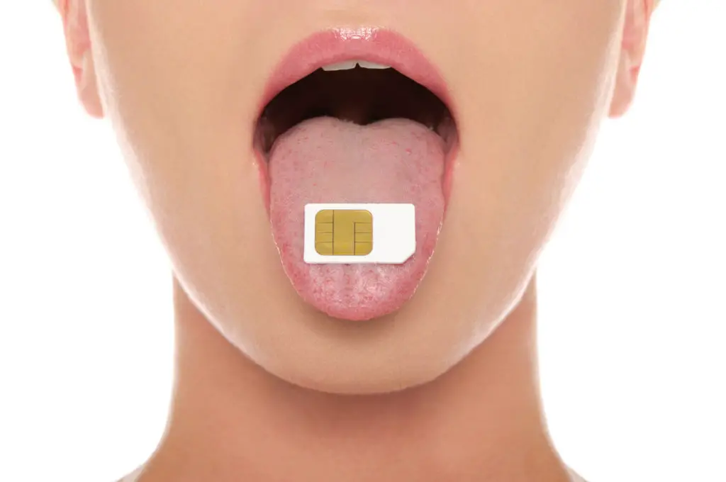Woman with a sim chip on her tongue.