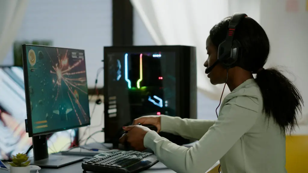 Black girl playing online computer game.