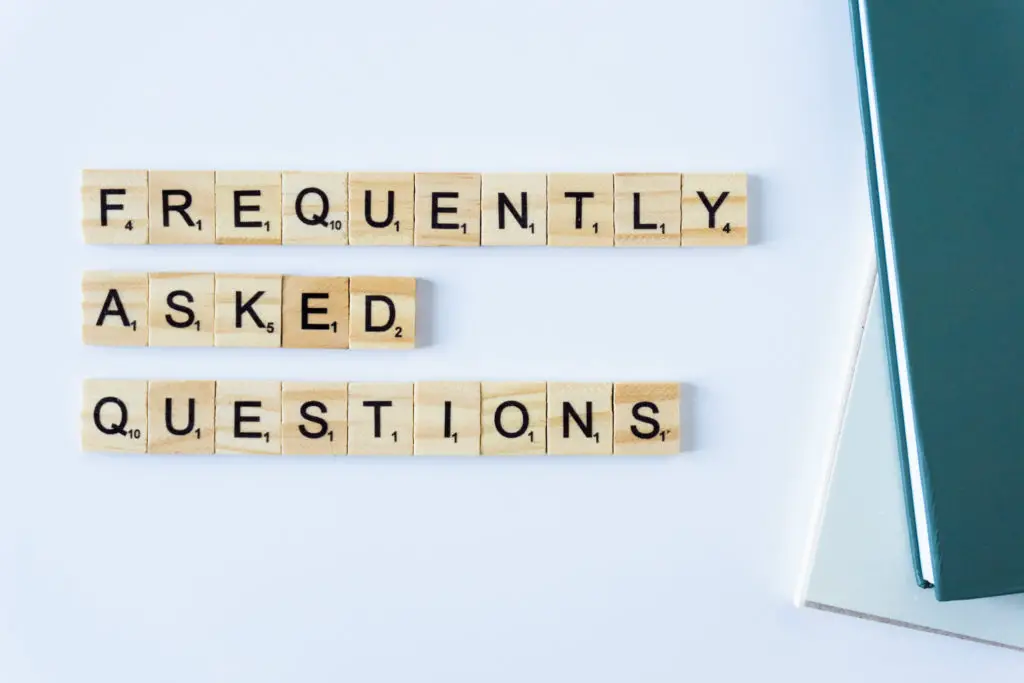 Frequently asked questions spelled out in scrabble letter tiles.