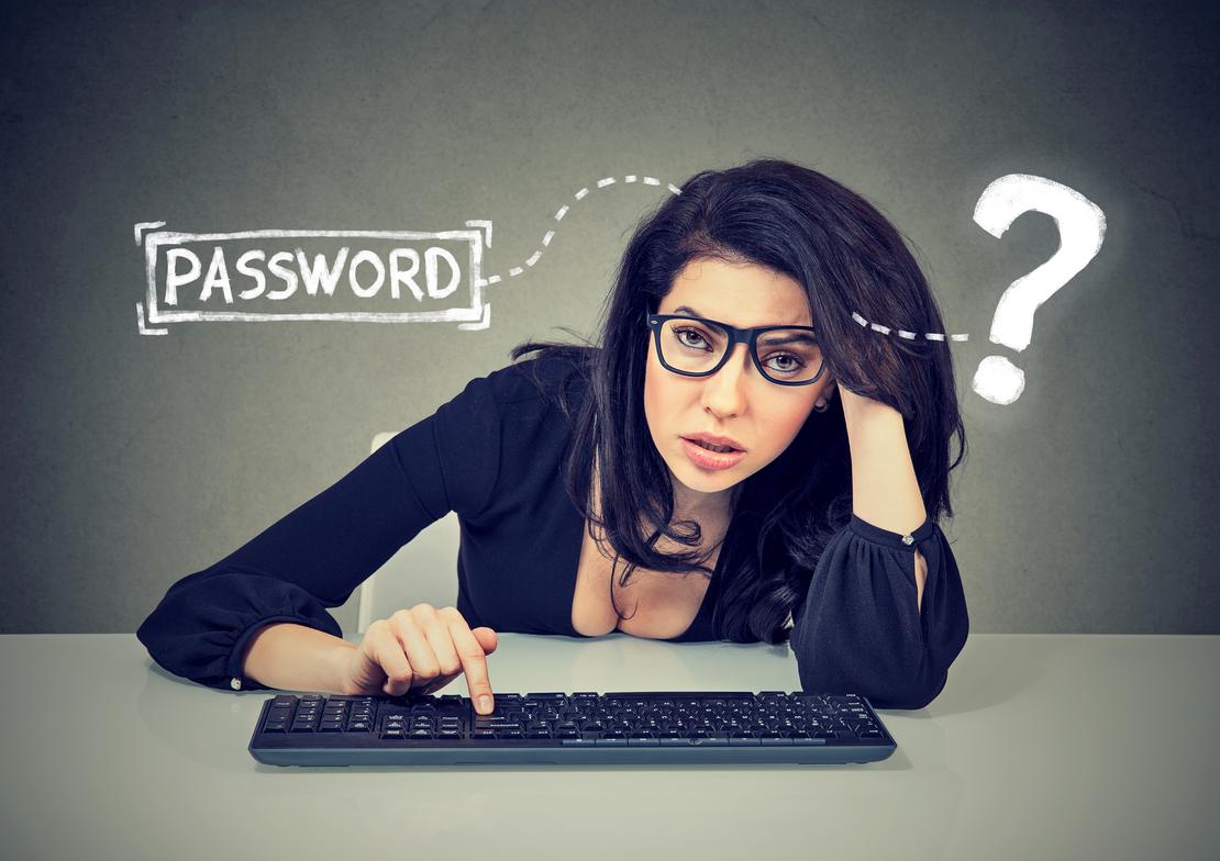 Upset woman typing on the keyboard trying to log into her computer forgot password