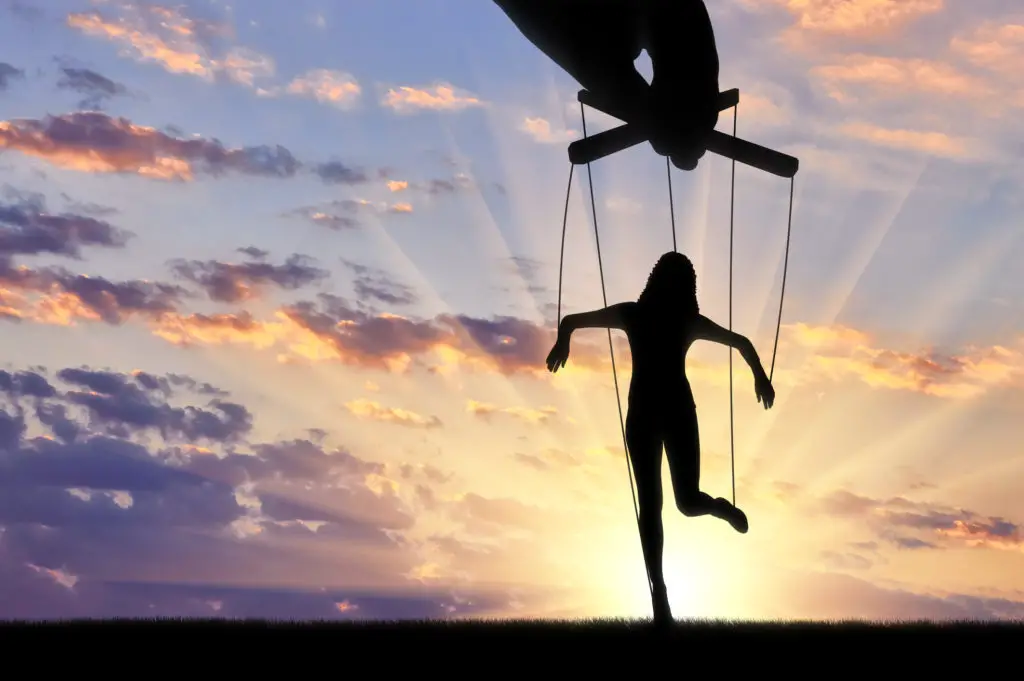 Sunrise with woman as a silhouette marionette as concept for being the weakest link in cybersecurity