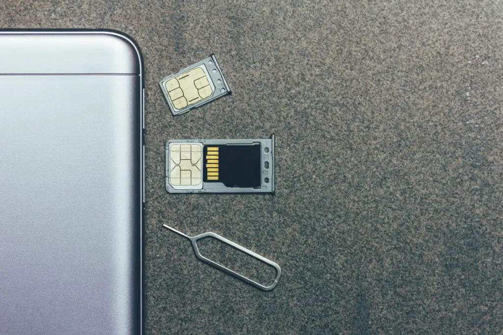 Close up of an ejected smartphone sim tray showing both a sim card and sd card difference
