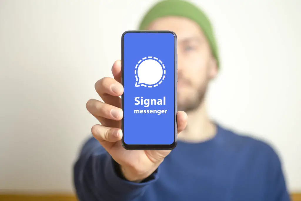Signal messenger app. Smartphone screen with messenger app signal at hand