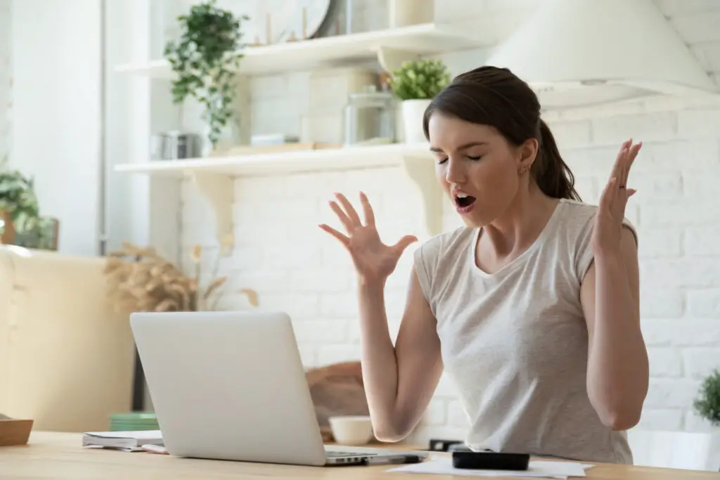 Angry woman with laptop trying to email files larger than 25mb