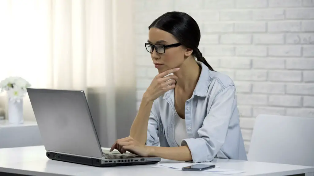 Woman using laptop wondering is an email address personal data.