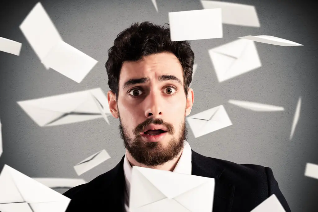 Envelopes falling from above around, a surprised man who is wondering why he's suddenly receiving lots of spam emails